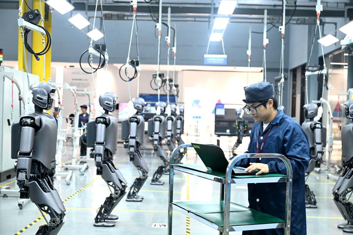 　　2025年6月18日，在广西柳州市北部生态新区机器人产业园，工人检查工业版人形机器人。新华社发（黎寒池摄）