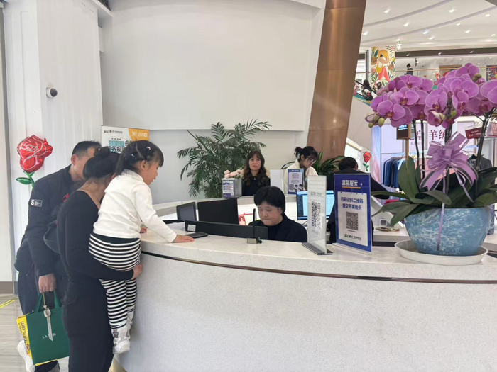 市民在商场服务台咨询有奖发票相关事宜，工作人员耐心解答。劳动报记者陆燕婷 摄影
