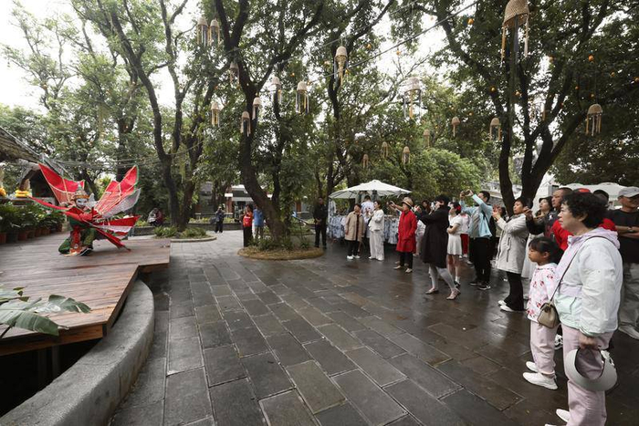 游客在西双版纳热带花卉园观看傣族民间舞蹈。 周灿 摄