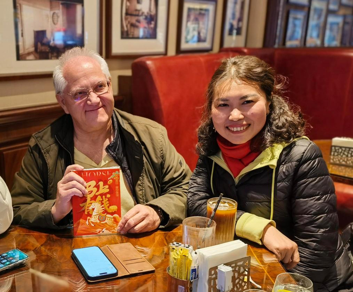 2月16日，希腊游客（左）与导游（右）在上海一家咖啡厅合影。新华社记者 陈爱平 摄