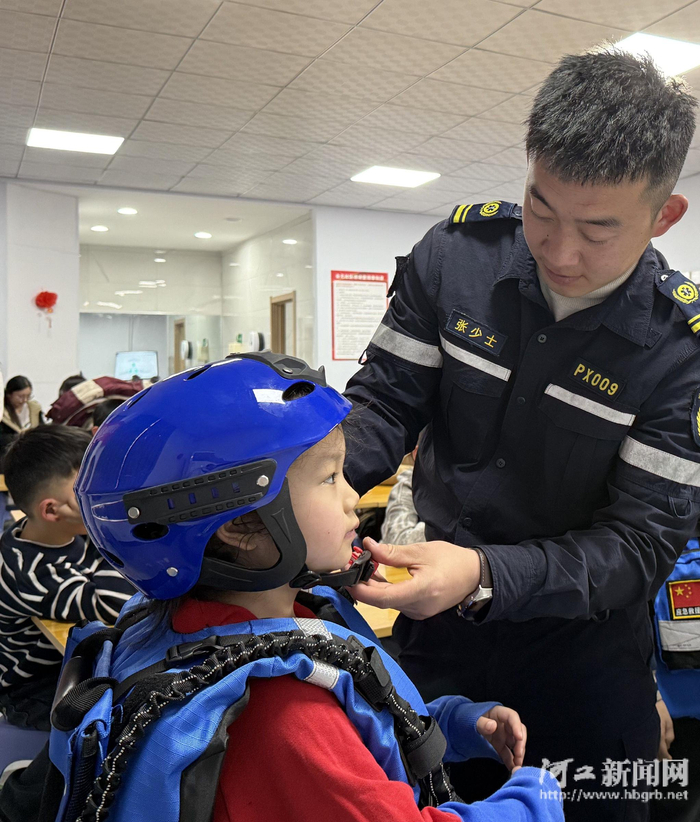 蓝天救援队队员给孩子们示范救援服穿戴