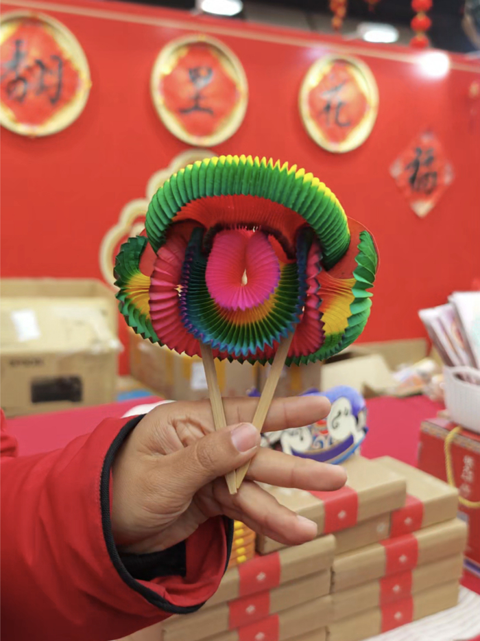 “翻里花”的经典样式，两张纸，两根棍，里面是三朵小花芽。新京报记者 王巍 摄