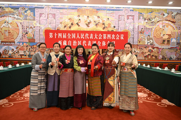 图为我区全国人大代表中的“七朵金花”在会场合影留念，并祝福全区妇女同胞“三八”国际劳动妇女节快乐。