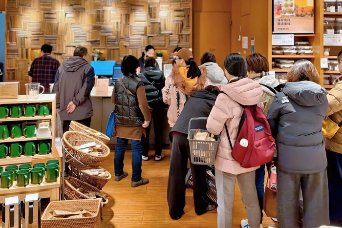 MUJI淮海755旗舰店内，满载而归的消费者正在排队结账。