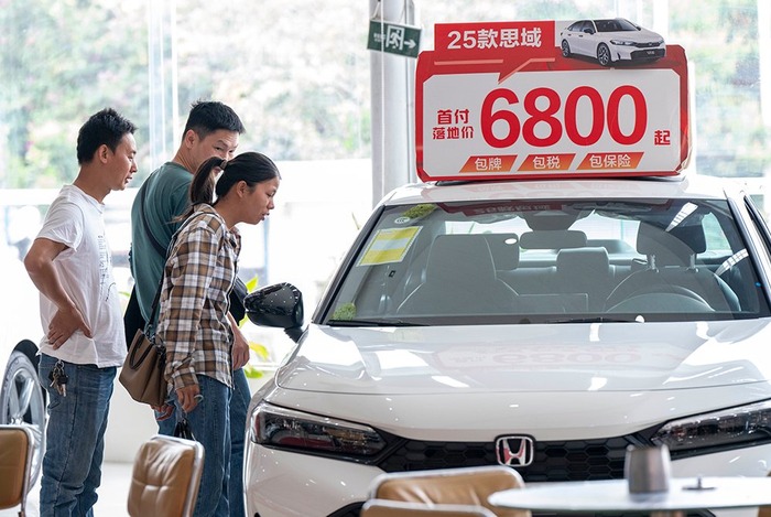广西梧州市一家汽车专卖店顾客在了解车型 图片来源：中国图片社
