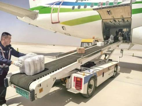 工作人员将货物送上飞机。图片来源于茫崖融媒