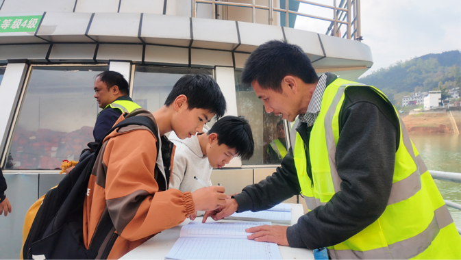 在工作人员引导下，乘船前学生签到。人民网记者 刘怡摄