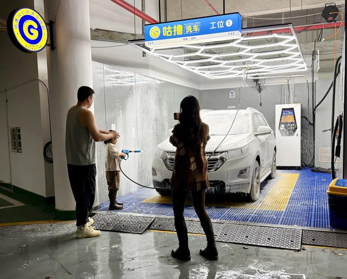 一家三口来洗车，妈妈为“小小洗车工”录制视频。 受访者提供