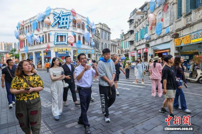　　3月20日，台湾青年参访海口骑楼老街，感受海口城市发展与文化传承的融合之美。　中新社记者 骆云飞 摄