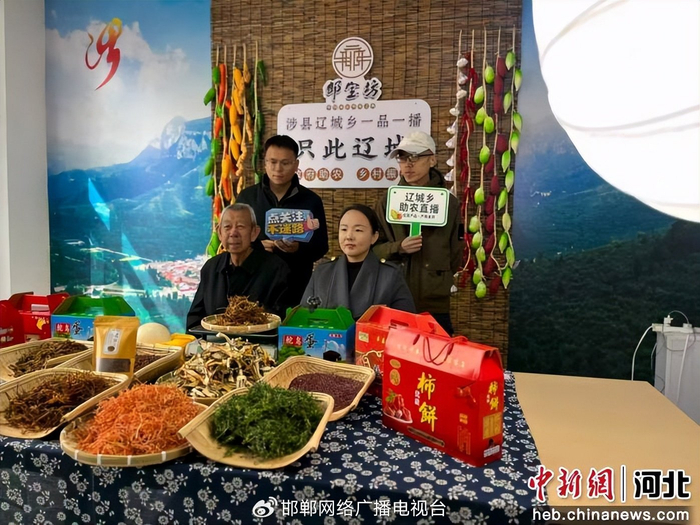 图为村民主播与工作人员推介本地特色农产品。 武志强 摄