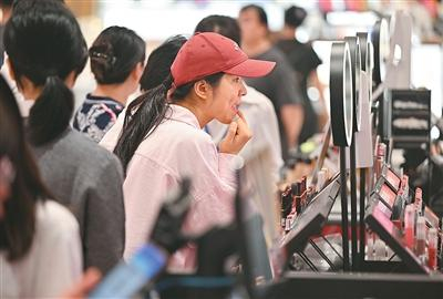 2月16日，顾客在海南海口日月广场免税店试用、选购化妆品。新华社记者 郭 程摄