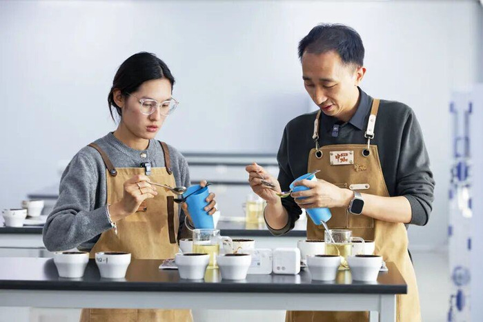 杨竹（右）和同事在做咖啡杯测（摄于1月14日）。新华网 赵普凡 摄