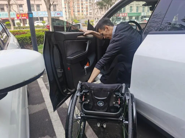于文涛向记者展示上车及轮椅折叠步骤