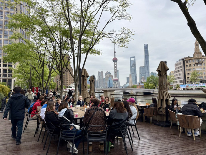4月23日，外国游客在苏州河畔（虹口段）休憩。