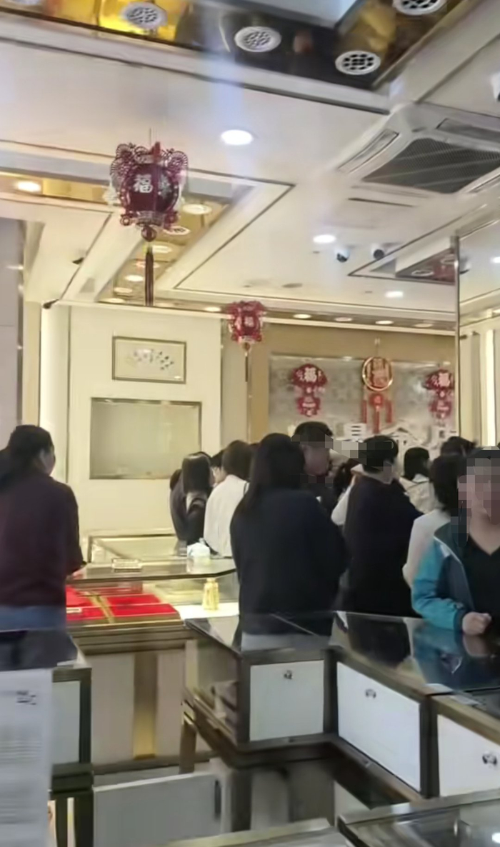 　　多名市民围在金店的收银台（视频截图）