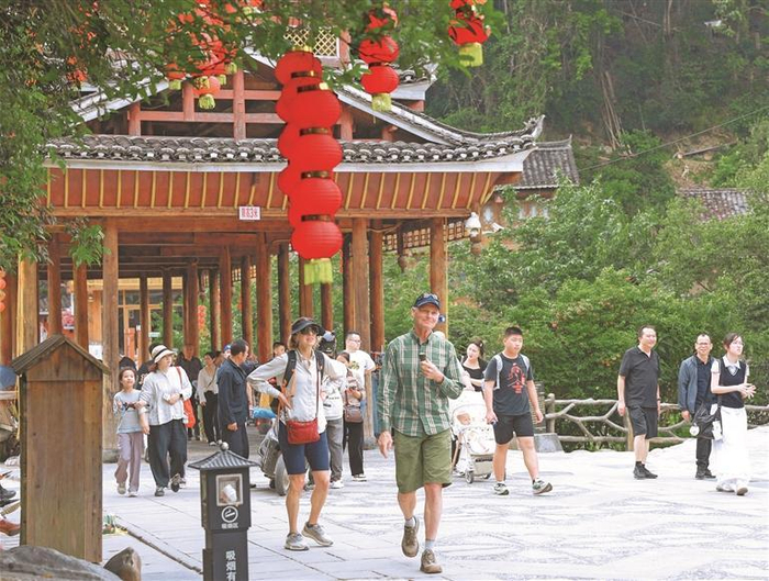 5月2日，外国游客在黔东南州黎平县肇兴侗寨旅游，沉浸式感受当地多姿多彩的民族文化。 新华社发 （梁辉波 摄）
