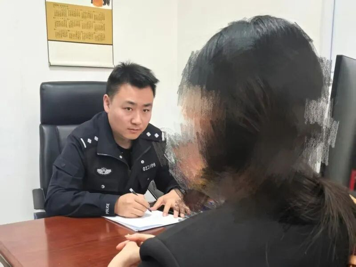 李女士向民警讲述被骗经过。蒋蕊摄