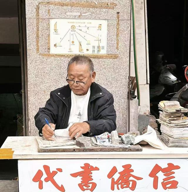 姜明典在小摊前写信。受访者供图