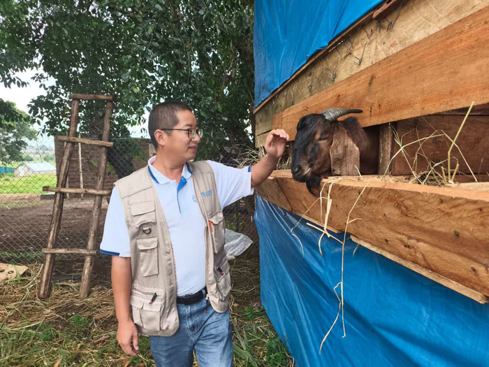 项目专家组畜牧专家张长勇和引进到乌干达的简州大耳羊。受访者供图