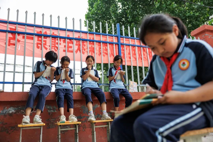 ▲5月12日，谷疃小学的孩子们坐在一起写诗。新京报记者 王子诚 摄