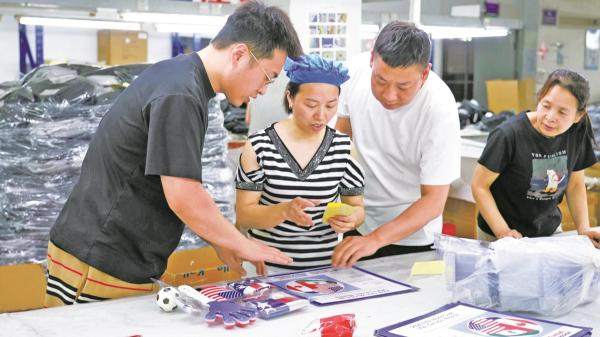 宁波禾源纺织品有限公司员工正在生产世界杯相关产品。 （王佳辉 方舟 摄）