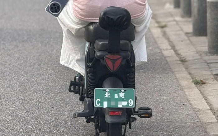 6月8日，北京市朝阳区石门中路，一位市民的电动自行车悬挂了新式号牌。新京报记者 王贵彬 摄