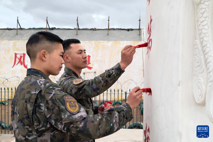 　　6月11日，武警青海总队海西支队执勤九中队战士杨俊（右）和张鑫为“长江源头第一桥”纪念碑描红。新华社记者 张铖 摄