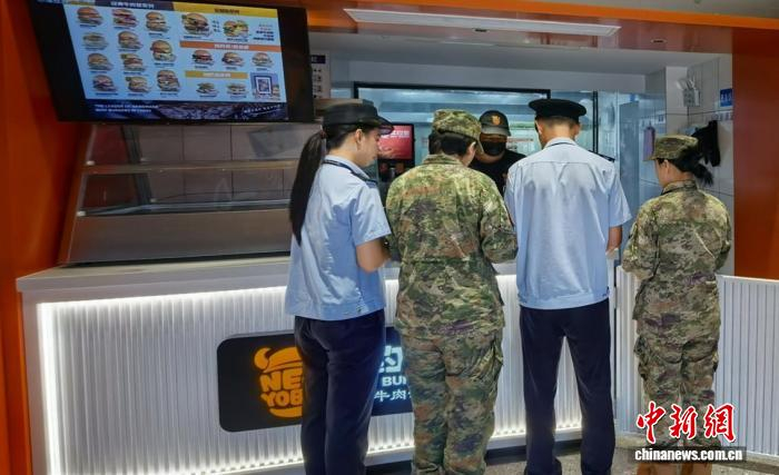 图为广西北海市场监管部门执法员和女民兵开展食品安全巡查。林浩 摄