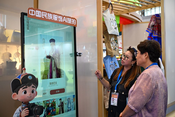  9月3日，参观者在博览会文旅产业融合展区了解中国民族服饰AI旅拍。新华社记者 孙凡越 摄