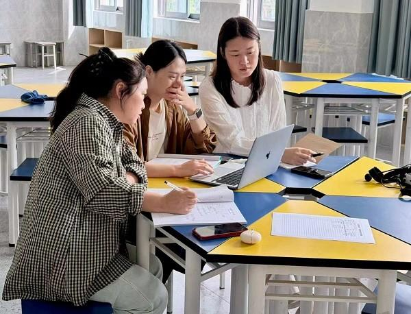 图：四川省德阳市涪江路小学校的王老师（左）、邱老师（中）、任老师（右）在课上进行模拟操作