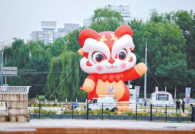 2026北京动画周的吉祥物“小狮福”伫立在北京展览馆南侧，超大尺寸的卡通气模憨态可掬。主办方供图