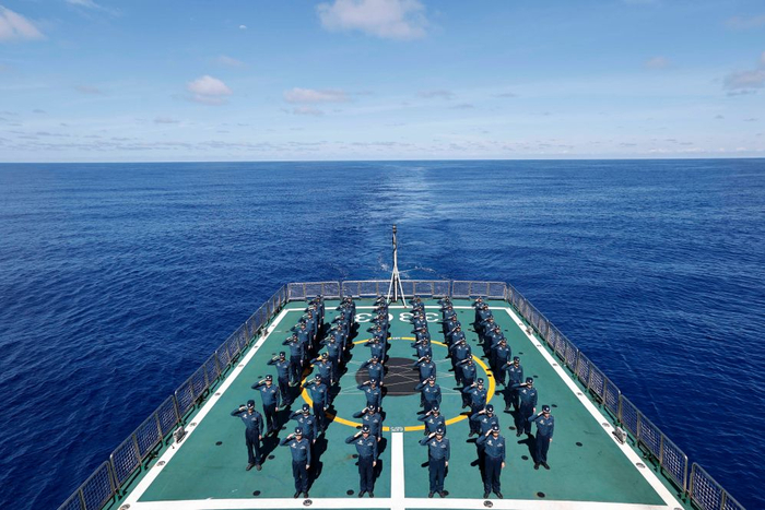   海警海陵舰在南海黄岩岛海域巡航时，在飞行甲板举行升旗仪式（无人机照片，8月1日摄）。
