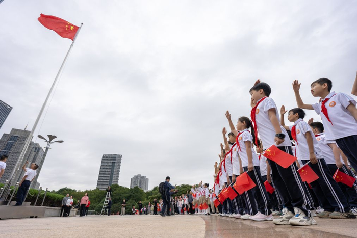 10月1日，湖北省武昌实验中学沙湖学校学生在武汉洪山广场参加升国旗仪式。新华社记者 肖艺九 摄