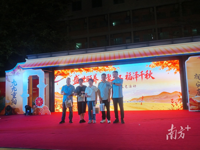 三水区委常委、统战部部长黄聪为参与敬老爱老服务的志愿者代表送上礼物。魏英 摄