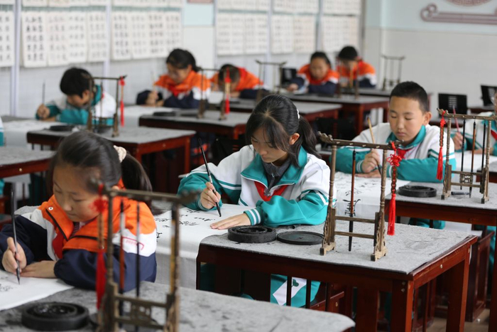 10月26日，甘肃省定西市通渭县文庙街小学的学生在书法课上写《七律·长征》。新华社发（王克贤 摄）