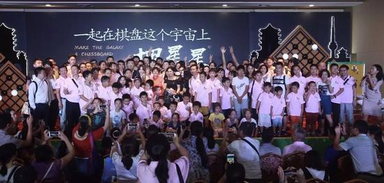 明星见面会上棋迷们争相与明星棋手合影