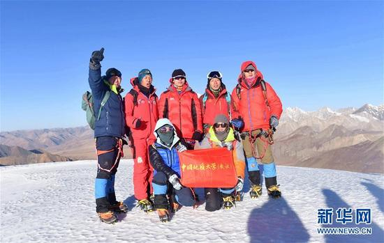 ↑11月7日，中国地质大学（武汉）研究生陶黎明（后排右一）和他的同学一起在山顶庆祝顺利登顶。新华社记者晋美多吉摄