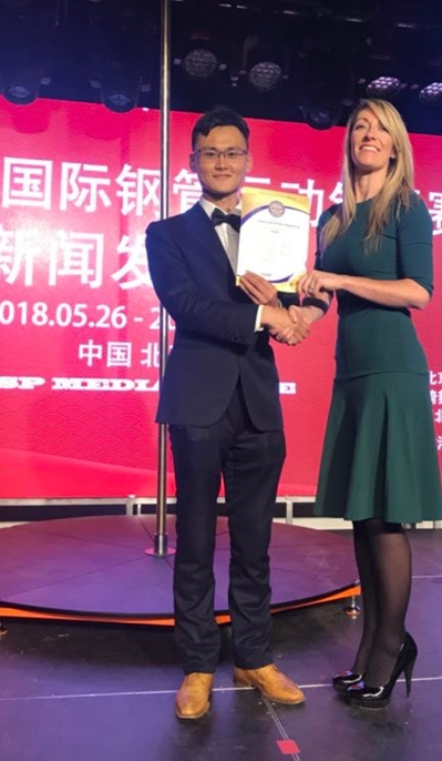 国际钢管运动联合会主席的凯蒂·科茨为国际钢管联合会中国区主席任飞颁发证书