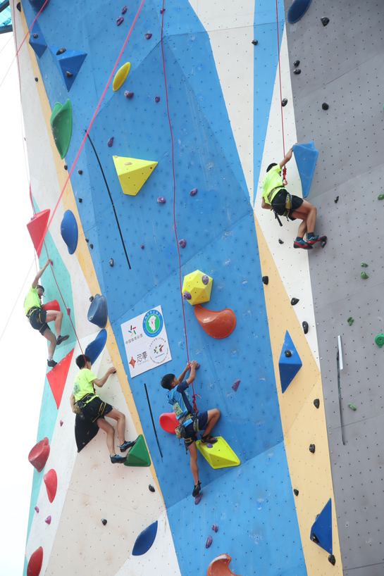 男子难度线路组小运动员们正在努力攀爬