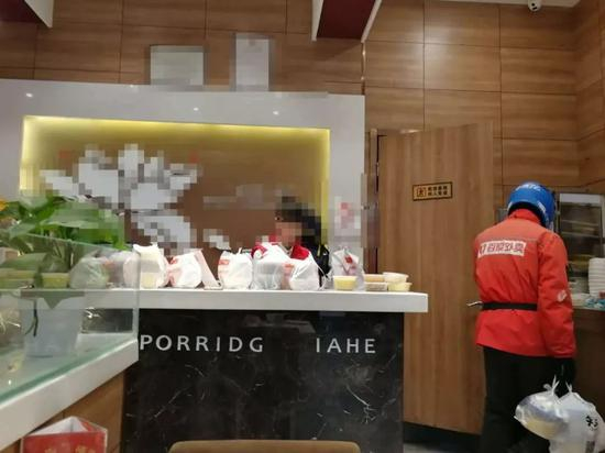 某餐厅柜台上摆满了等待配送的外卖
