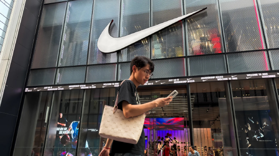 2026 年 5 月 31 日，中国广东省深圳市，一名行人一边看手机一边从耐克门店旁走过。