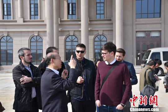 图为：外国专家正在与中国工程师交流　范宇斌　摄