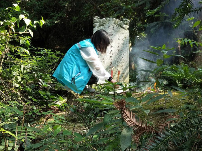 　　衡阳县台源寺附近，志愿者正在牺牲伞兵的墓前祭扫。日前，有三人的身份已得到确认。 组图/受访者提供