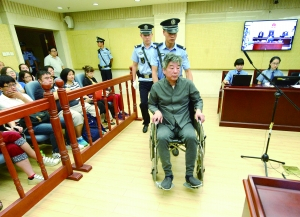 李宝俊坐轮椅受审