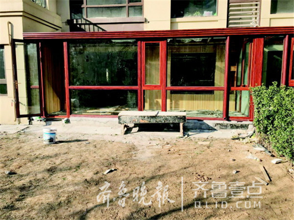 有一楼的业主装修时将绿地全部破坏，封起了阳光房。齐鲁晚报·齐鲁壹点 记者刘雅菲 摄