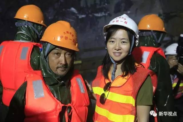  图为记者采访施工人员