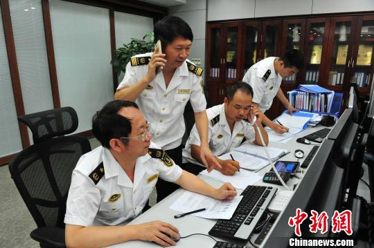 福建省搜救中心办公室主任、福建海事局副局长宋剑华(左一)指挥部署指挥救助行动。　黄智明 摄