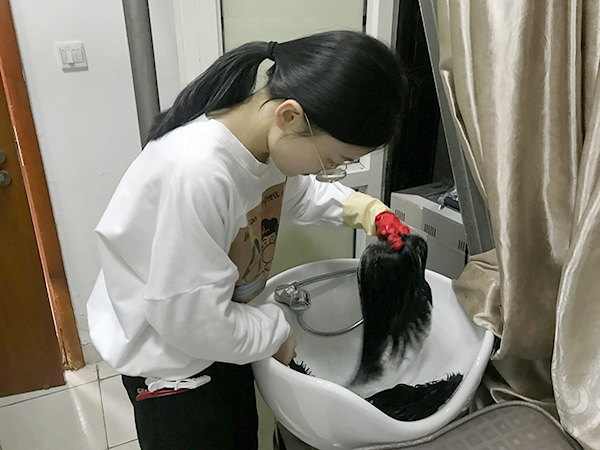 假发店的工作人员在洗护假发。 澎湃新闻记者 张维 图