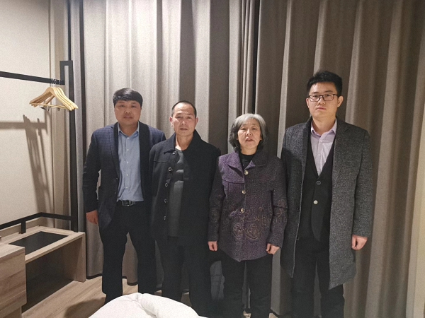 出狱后，王新元夫妇和代理律师殷清利（右一）、赵鹏（左一）在宾馆合影。 受访者 供图