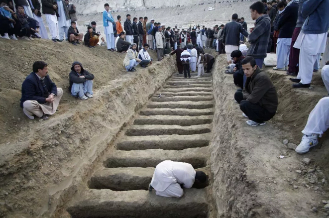  2013年2月奎达市场袭击案造成至少90人死亡，图中一男子正为遇难者掘墓。